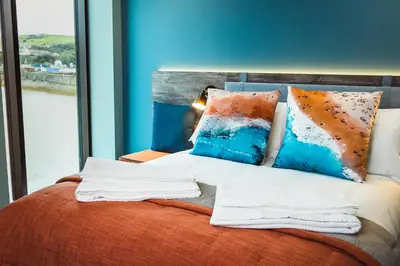 a bedroom with a bed with pillows and a window at The Edge in Whitehaven
