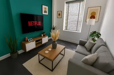 a living room with a couch and a tv at Armstrong St - Cosy 3 Bedroom Home in Workington