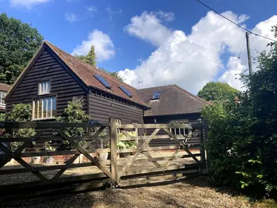 a wooden fence in front of a house at The Cart Barn in Moffat