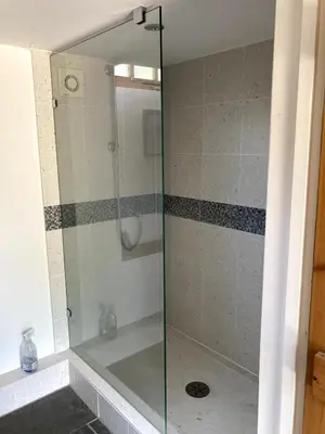 a shower with a glass door in a bathroom at The Cart Barn in Moffat