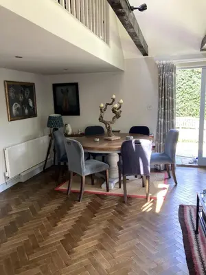 a dining room with a wooden table and chairs at The Cart Barn in Moffat