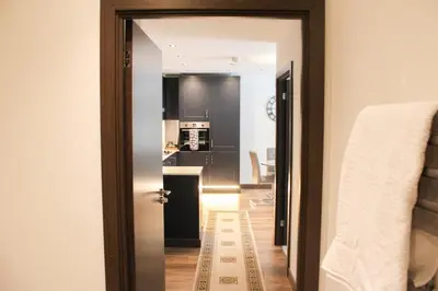 a hallway with a door leading to a kitchen at The Sunrise Den, Modern 2-Bed Apartment, Free Parking in Yarrow