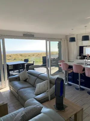 a living room with a couch and a table at The Beach House in Moffat
