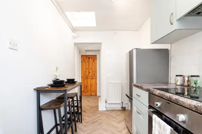 a kitchen with a refrigerator and a table at 2Bedroom House - Free Parking- by Holiday Homes in Annan