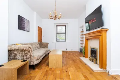 a living room with a couch and a fireplace at 2Bedroom House - Free Parking- by Holiday Homes in Annan