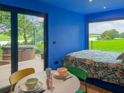 a room with a bed and a table with chairs and a window at Cassiopeia - Uk50360 in Castle Douglas