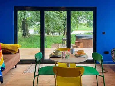 a dining room with a table and chairs in front of a window at Cassiopeia - Uk50360 in Castle Douglas