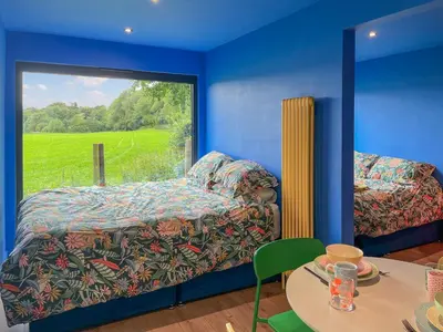 a room with a bed and a table and a window at Cassiopeia - Uk50360 in Castle Douglas