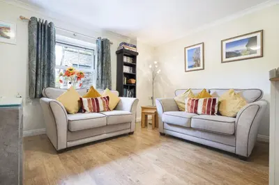 a living room with two couches and a window at The Screes Apartment - Short stroll from Wastwater - Herdwick Cottages