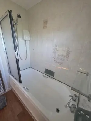 a bathroom with a shower and a bathtub with a shower at Lovely 3 Bedroom House 5 Minutes M6 or Carlisle in Carlisle