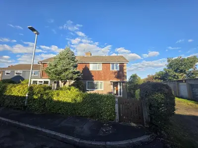 a brick house with a fence in a yard at Lovely 3 Bedroom House 5 Minutes M6 or Carlisle in Carlisle
