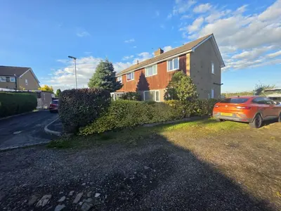 a red car parked in front of a house at Lovely 3 Bedroom House 5 Minutes M6 or Carlisle in Carlisle
