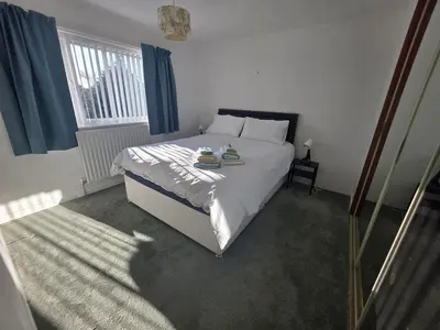 a bedroom with a bed and a window at Lovely 3 Bedroom House 5 Minutes M6 or Carlisle in Carlisle
