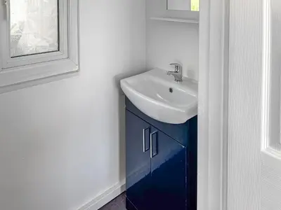 a bathroom with a sink and a blue cabinet at Revita in Egremont