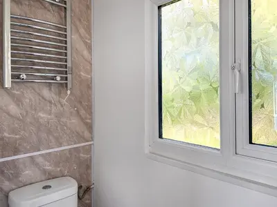 a bathroom with a window next to a toilet at Revita in Egremont