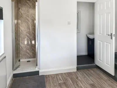 a bathroom with a shower with a glass door at Revita in Egremont