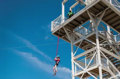 a person on a rope dangling from a tower at A&L Holiday Home Craigtara in Ayr