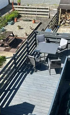 a picnic table and chairs on a wooden deck at The Attic Portpatrick in Portpatrick