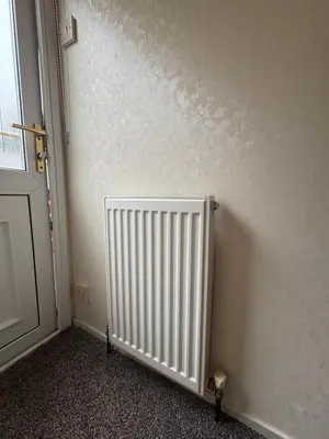 a radiator in a room next to a door at Cosy Caravan by the sea in Cairnryan
