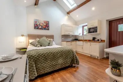 a large bedroom with a bed and a kitchen at 1 Bed in Wetheral oc-g32934 in Wreay