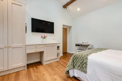 a bedroom with a bed and a desk with a tv at 1 Bed in Wetheral oc-g32934 in Wreay