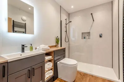 a bathroom with a shower and a toilet and a sink at 1 Bed in Wetheral oc-g32934 in Wreay
