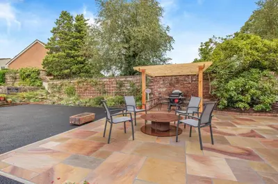 a patio with chairs and a table and a grill at 1 Bed in Wetheral oc-g32934 in Wreay