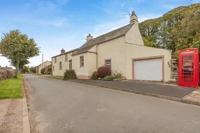 a red phone booth in front of a house at 4 Bed in Ellonby oc-y33284 in Ellonby