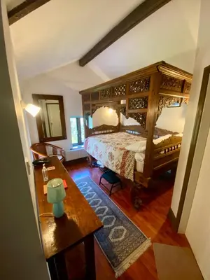 a bedroom with a canopy bed and a table at School House in Patterdale