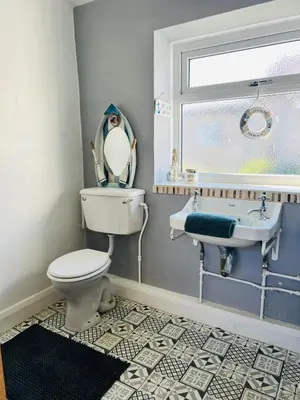 a bathroom with a toilet and a sink at Old Post Office By The Sea in Allonby
