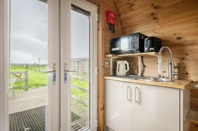 a kitchen with a sink and a microwave at Unit 3 - High Pike View Camping Pod in Carlisle