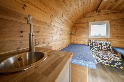 a bathroom with a sink in a wooden cabin at Unit 3 - High Pike View Camping Pod in Carlisle