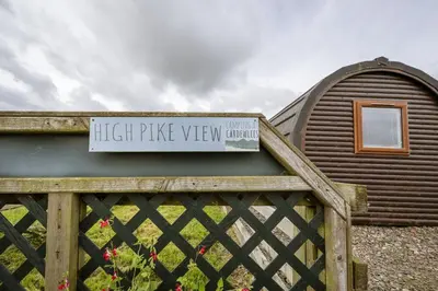 a sign on top of a wooden fence at Unit 3 - High Pike View Camping Pod in Carlisle