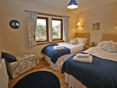 a hotel room with two beds and a window at Laggansally Lodge in Leswalt