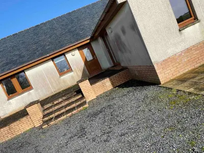 a house with a door and stairs in front of it at Laggansally Lodge in Leswalt