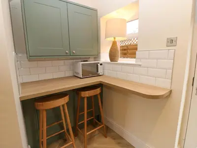 a kitchen with a counter with stools and a microwave at Milford in Carlisle