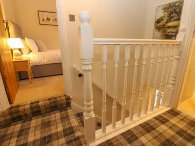 a staircase with white railings in a house at Milford in Carlisle
