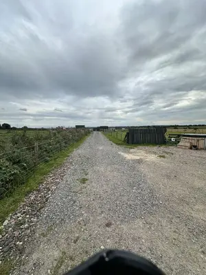 a dirt road in the middle of a field at Unit 0 - Fully Serviced All Weather Pitch with Hot Tub in Carlisle