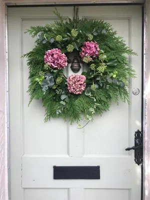 a wreath on the door of a white front door at Evas cottage near Scafell in Gosforth
