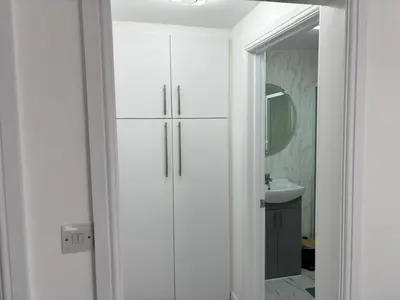 a bathroom with a white cabinet and a mirror at Favourland Home in Moffat