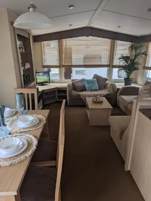 a living room with a couch and a table at 20 Chestnut Grove in Stranraer