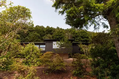 a house in the woods with trees at The Hideaway at Yew Trees, Ullswater in Watermillock
