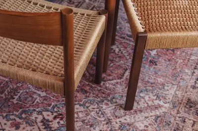 a wicker chair and a table on a rug at The Hideaway at Yew Trees, Ullswater in Watermillock