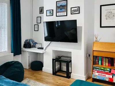 a living room with a flat screen tv on a wall at Miner's Rest in Frizington