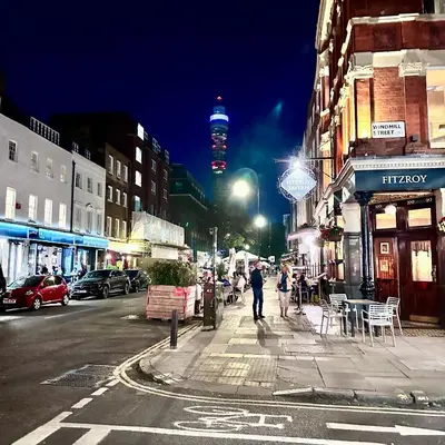 a city street at night with people walking on the sidewalk at Central London Designer Room with Balcony Elevator in Moffat