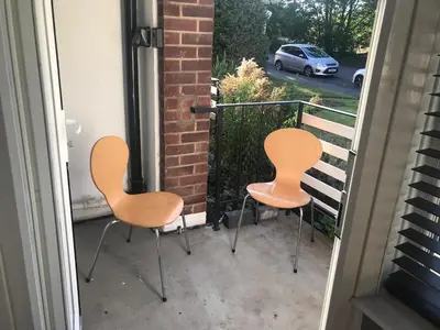 two chairs sitting on a balcony looking out the window at 2 new bold lawns leamington spa in Moffat
