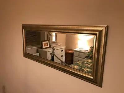 a mirror hanging on a wall with a room at 2 new bold lawns leamington spa in Moffat