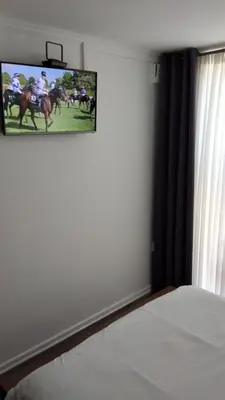 a bedroom with a bed and a tv on the wall at Pazuri Apart in Moffat