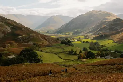 people standing on a hill looking at a valley with mountains at Landal Whitbarrow in Penruddock