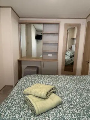 a bedroom with a bed with two towels on it at Deblisa in Longtown